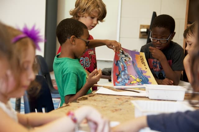Teacher supporting a child in a classroom setting
